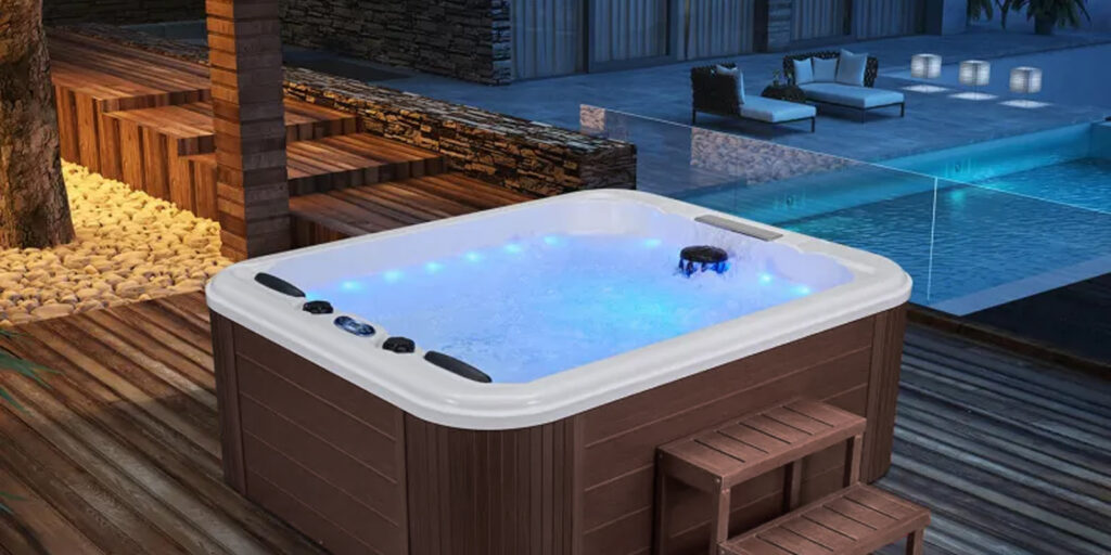 Spa 5 places Dacca illuminé sur une terrasse en bois